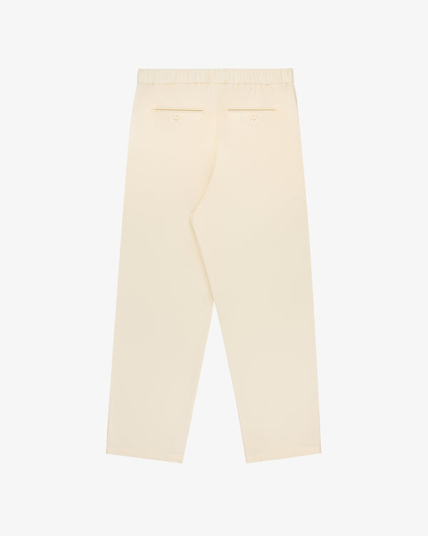 Back view of Cotton Casual Pant in beige with elastic waist and back welt pockets, shown on a white background.