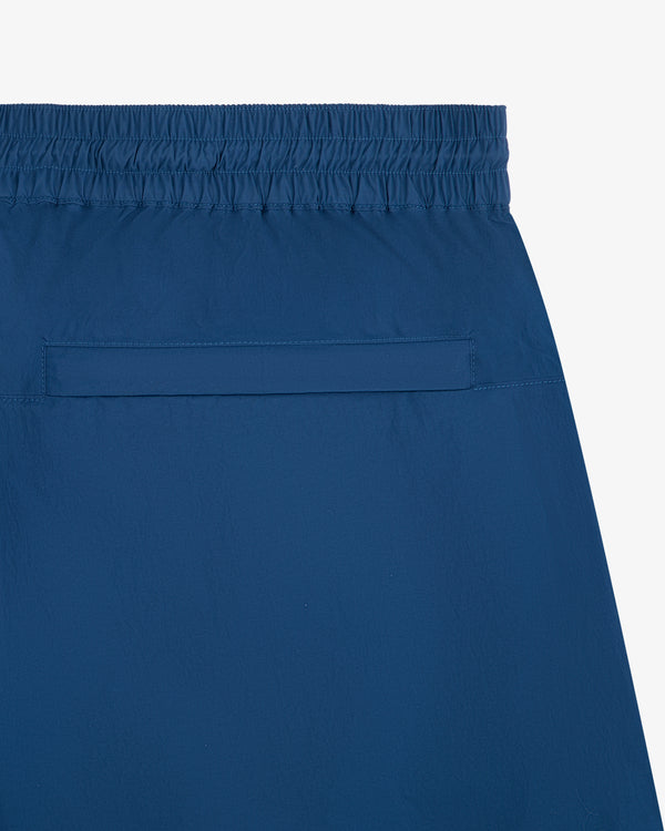 Close-up of the back pocket and waistband of Windbreaker Pant with an elastic waist and horizontal pocket.