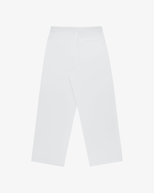 Windbreaker Pant in white, high-waisted with a single back pocket and wide-leg, shown from the back on plain background.