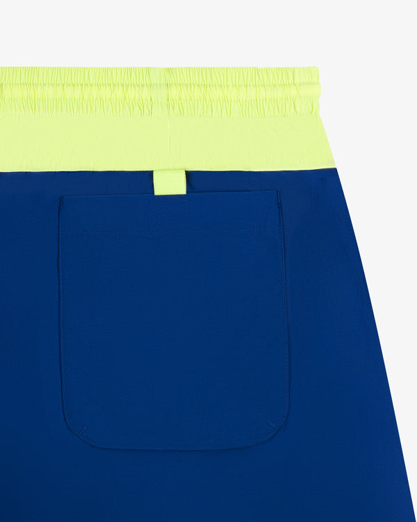 Paneled Sport Short: blue with neon yellow waistband, single large back pocket, shown on a white background.