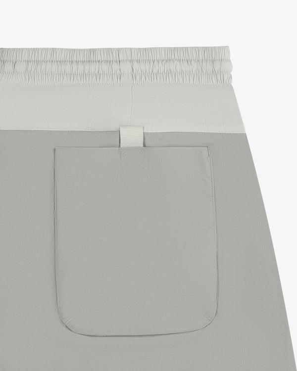 Close-up of Paneled Sport Short in light gray with elastic waistband and single back pocket.