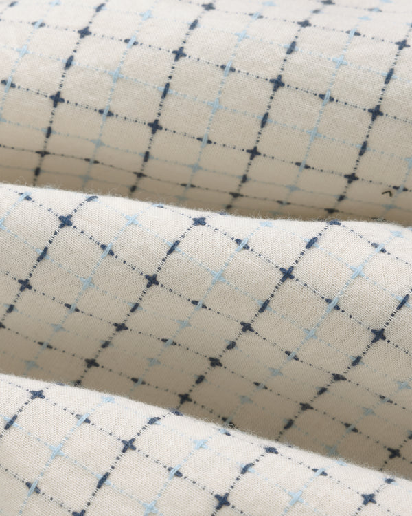 Close-up of Lightweight Patterned Leisure Shirt in cream with blue and navy grid, shown folded softly.
