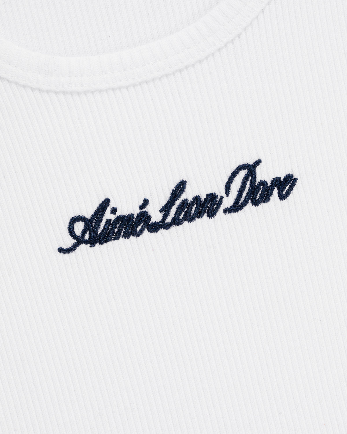 White ribbed Embroidered Logo Tank Top featuring Aimé Leon Dore stitched in black cursive on the chest.