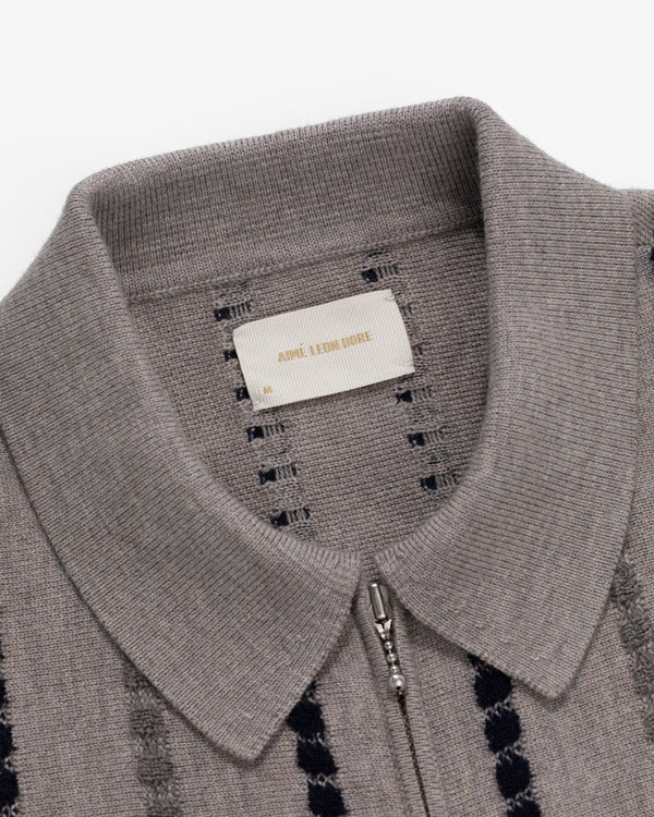 Close-up of a gray Jacquard Stripe Polo Cardigan with zipper and visible Aimé Leon Dore label inside the collar.
