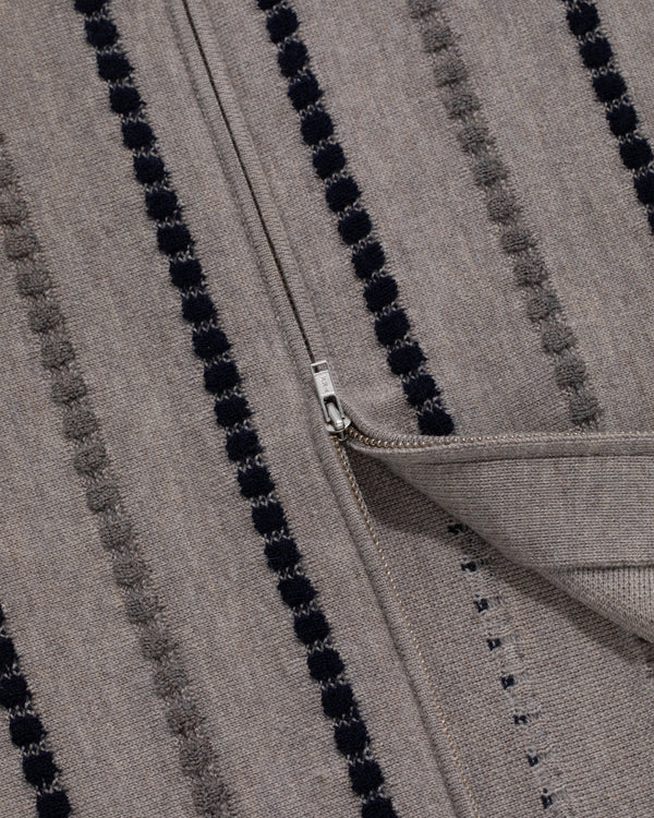 Close-up of the Jacquard Stripe Polo Cardigan in gray with black dotted stripes and a silver zipper.