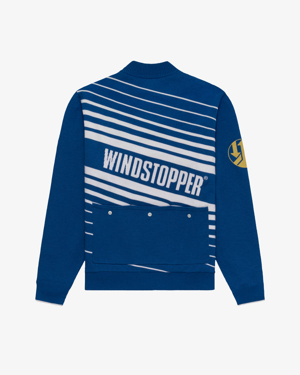 Blue WINDSTOPPER® cycling jersey with white stripes and a yellow left-sleeve patch by GORE-TEX LABS.