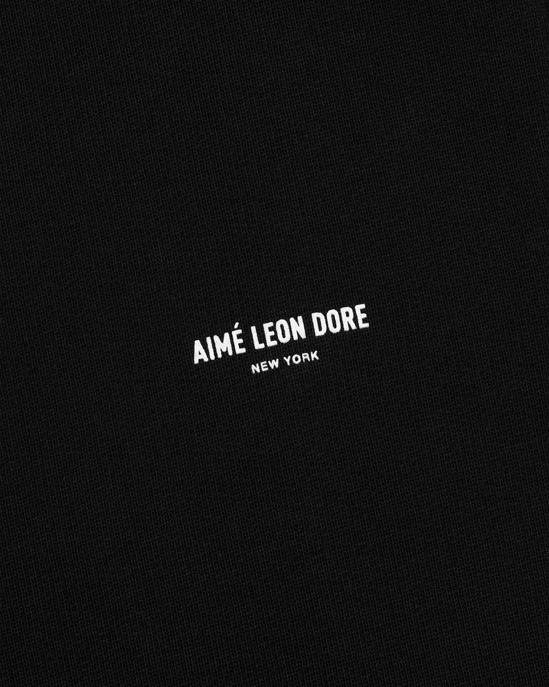Black fabric sweatpants with small white AIMÉ LEON DORE NEW YORK logo centered on the front.