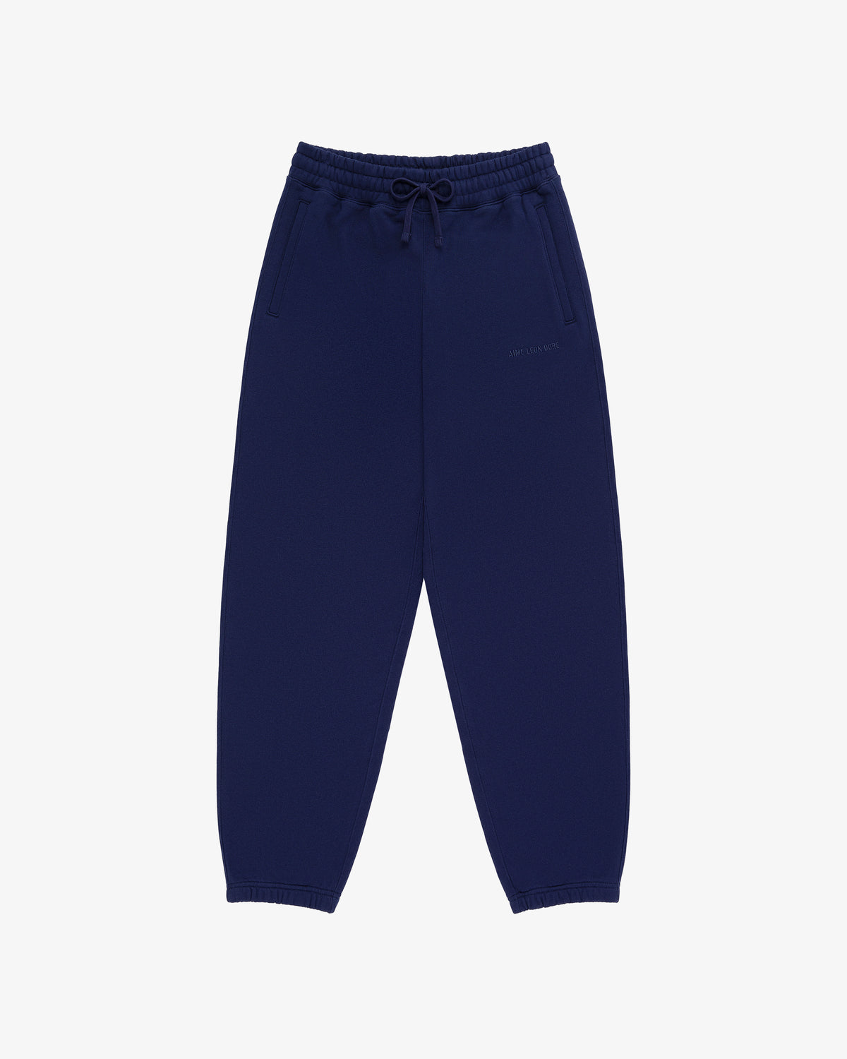 Tonal Logo Sweatpants in navy blue with elastic waistband, drawstring, side pockets, and elastic cuffs on white background.