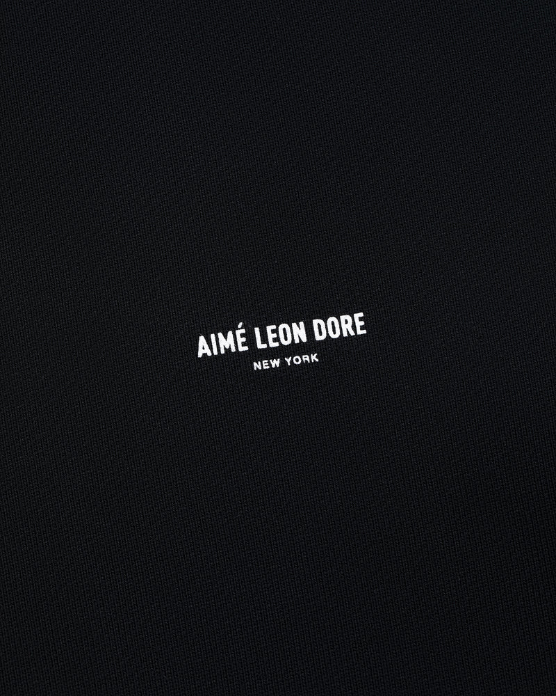 Black Micro Logo Crewneck Sweatshirt with small white AIMÉ LEON DORE NEW YORK text centered on front.