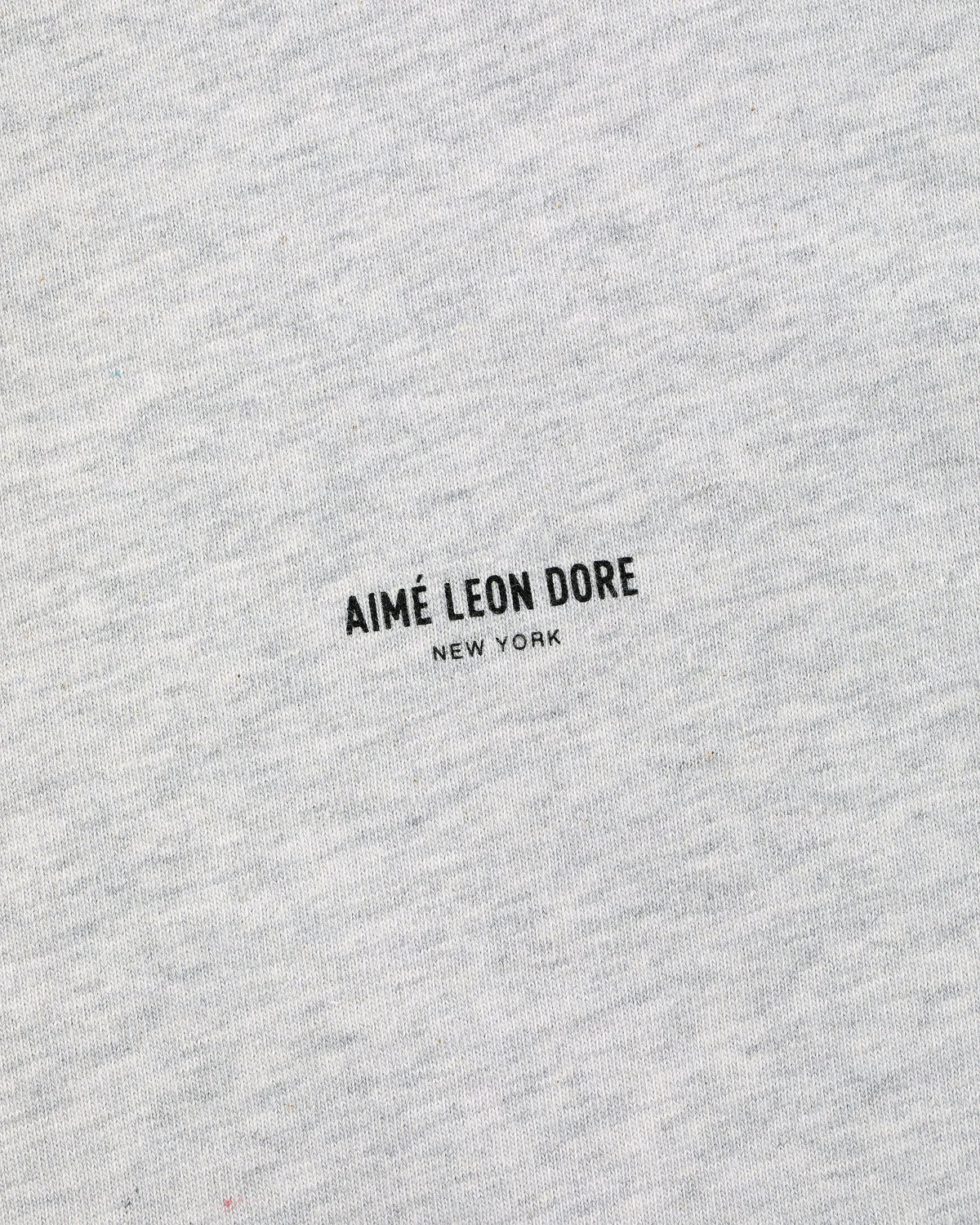 Close-up of a gray Micro Logo Tee with small black AIMÉ LEON DORE NEW YORK print in the center.