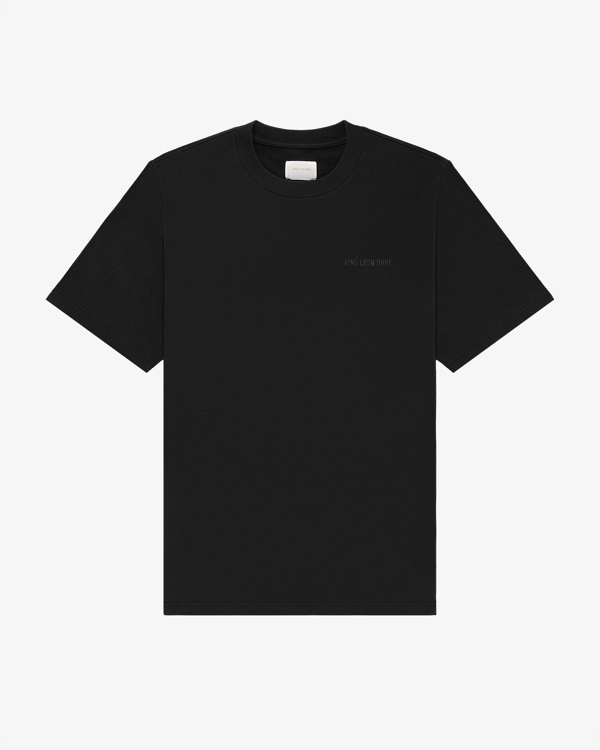 Tonal Logo Tee in plain black with subtle left chest text, short sleeves, shown on a white background.