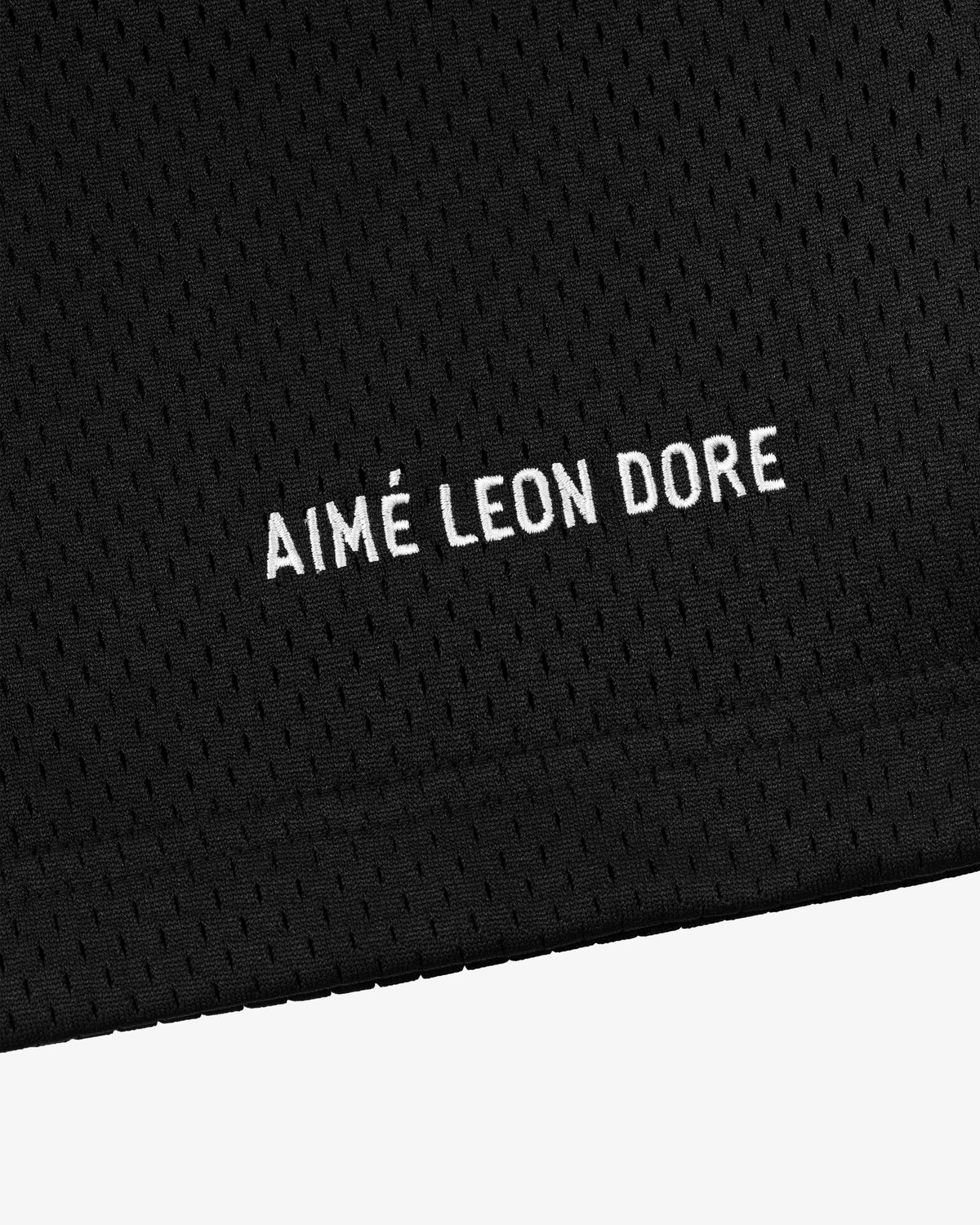 Black mesh Logo Gym Short with AIMÉ LEON DORE embroidered in white, centered near the bottom edge.