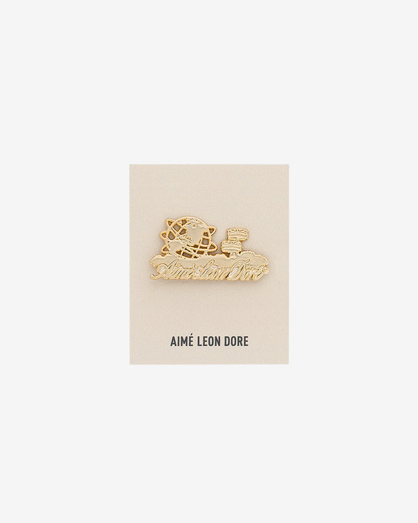 ALD Pin: gold pin with globe, basketball, and script on AIMÉ LEON DORE card, shown on white background.