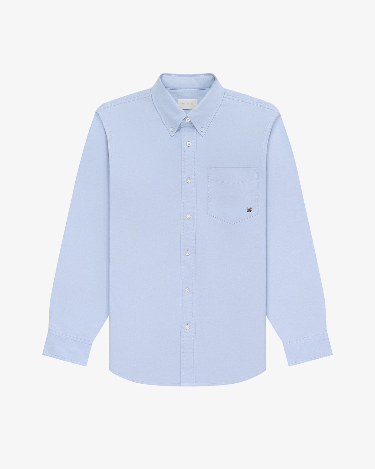 Crest Oxford Shirt in light blue, long sleeves, button-up with chest pocket, on a white background.