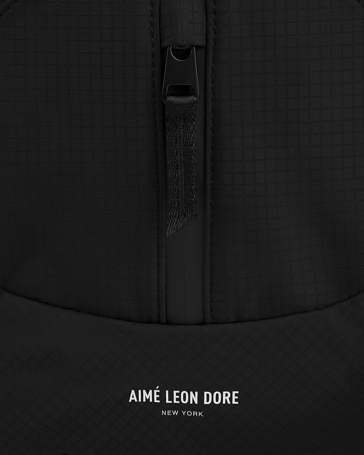 Close-up of the black Nylon Messenger Bag with a zipper and AIMÉ LEON DORE NEW YORK printed in white.
