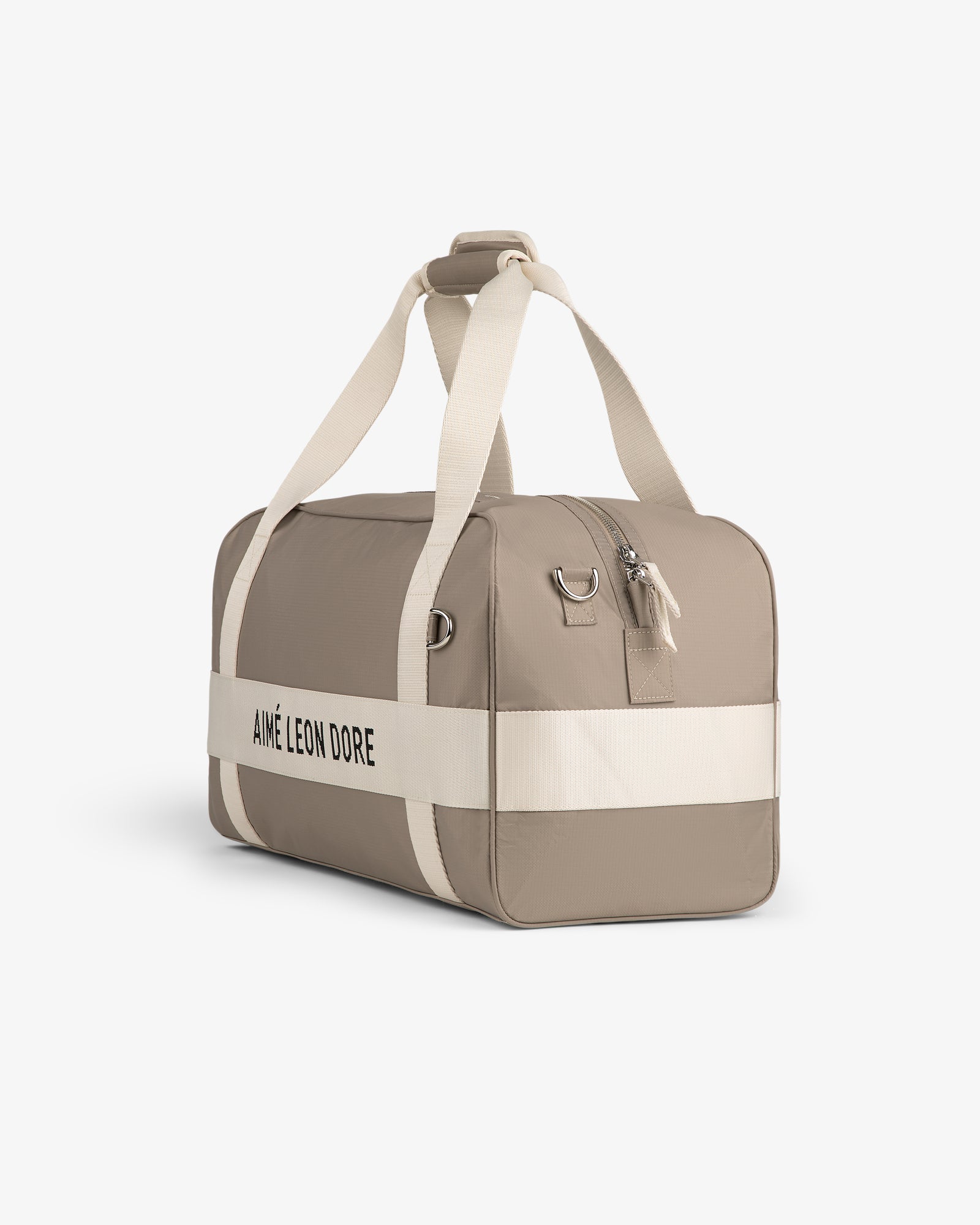 Nylon Duffle Bag in beige with white straps and black AIMÉ LEON DORE text, shown on a white background.