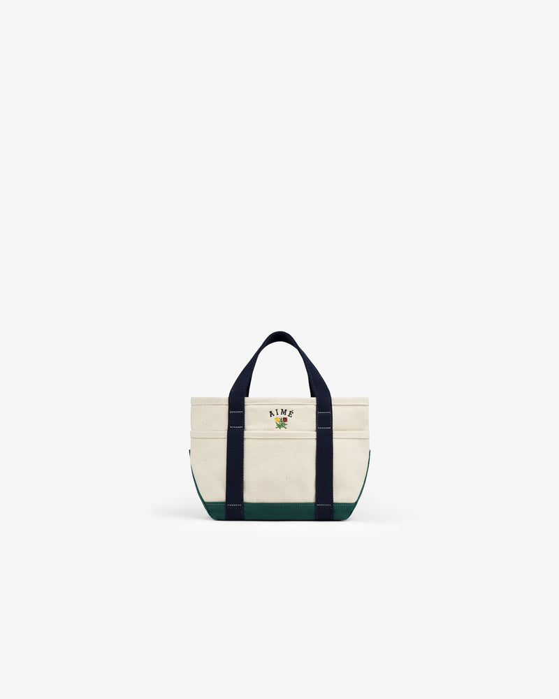 Mini Crest Contrast Tote Bag with dark handles, green base, and AIME text with graphic on the front.
