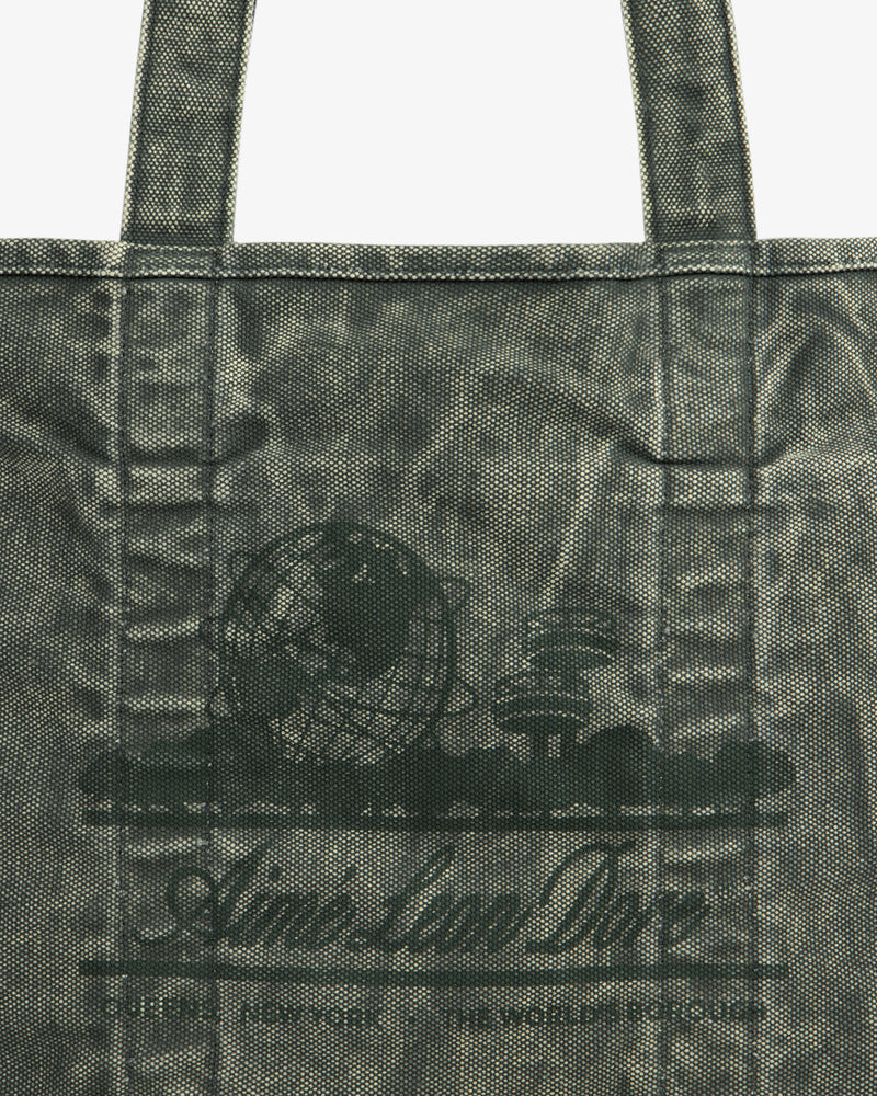 Close-up of the Sun Faded Large Unisphere Tote Bag with a printed globe, books, and "Aim-Lan Doe" on the front.