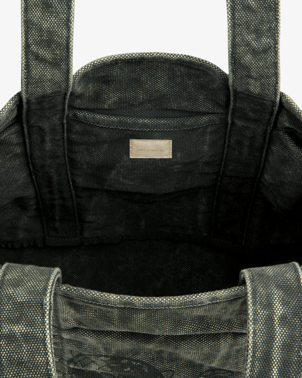 Close-up of the Sun Faded Large Unisphere Tote Bag's textured gray interior with handles and a small inside label.