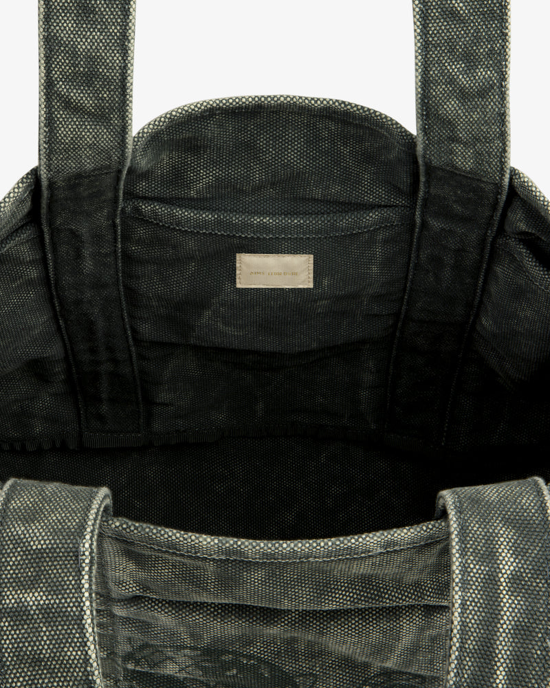 Close-up of the Sun Faded Large Unisphere Tote Bag's textured gray interior with handles and a small inside label.