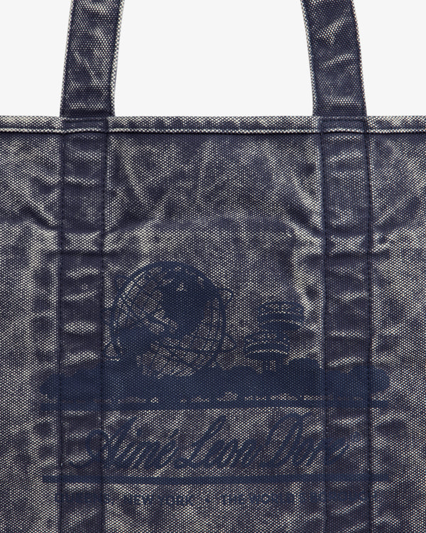 Close-up of the Sun Faded Large Unisphere Tote Bag, featuring a blue textured finish, handles, and a subtle front design.