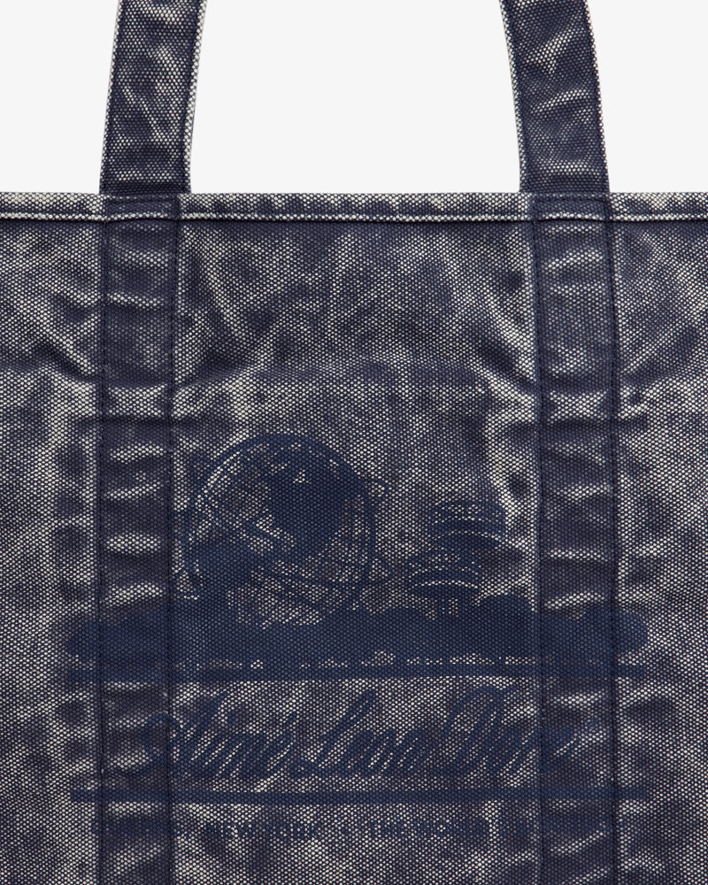 Close-up of the Sun Faded Large Unisphere Tote Bag, featuring a blue textured finish, handles, and a subtle front design.