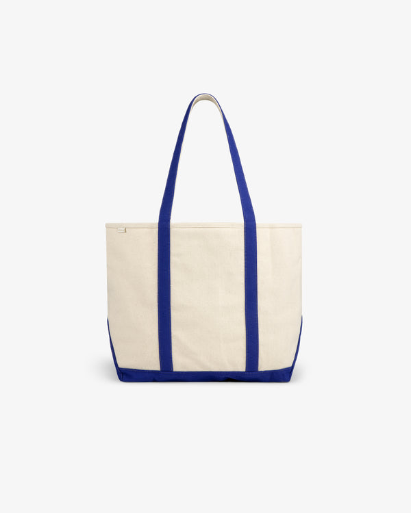 Krylon Tote Bag in beige canvas with blue handles and trim, displayed on a plain white background.