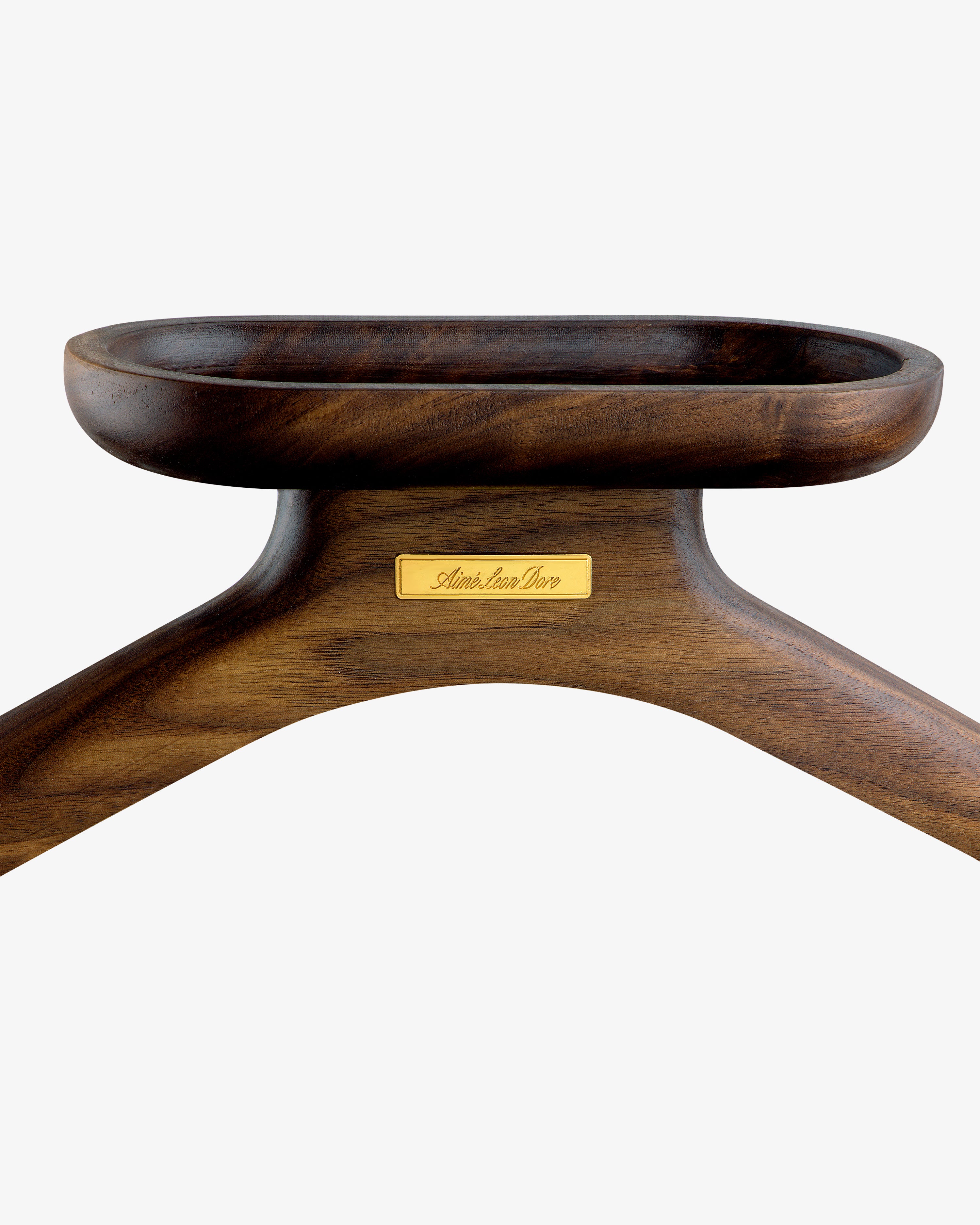 Close-up of a dark wooden Queens Crest Valet Chair featuring a gold nameplate on a white background.