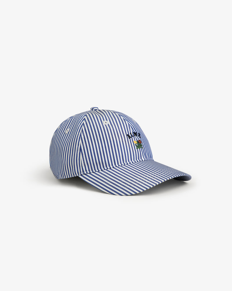 Striped Crest Logo Hat with blue and white stripes, small embroidered flower, and LOVE text on the front.