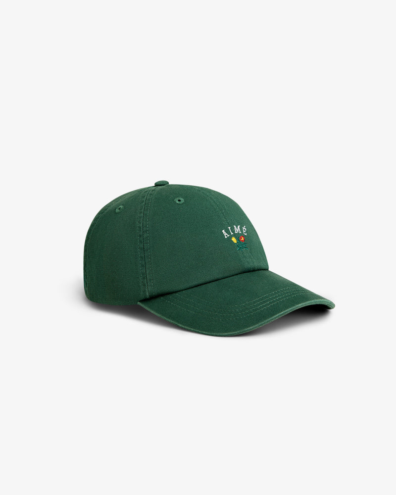 A green Crest Logo Hat with a small, colorful embroidered design and the word ALIME on the front.