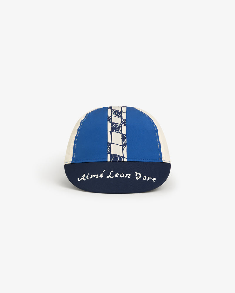 The Fassianos Cycling Cap is blue and white with a checkered stripe and Aimé Leon Dore on the brim.