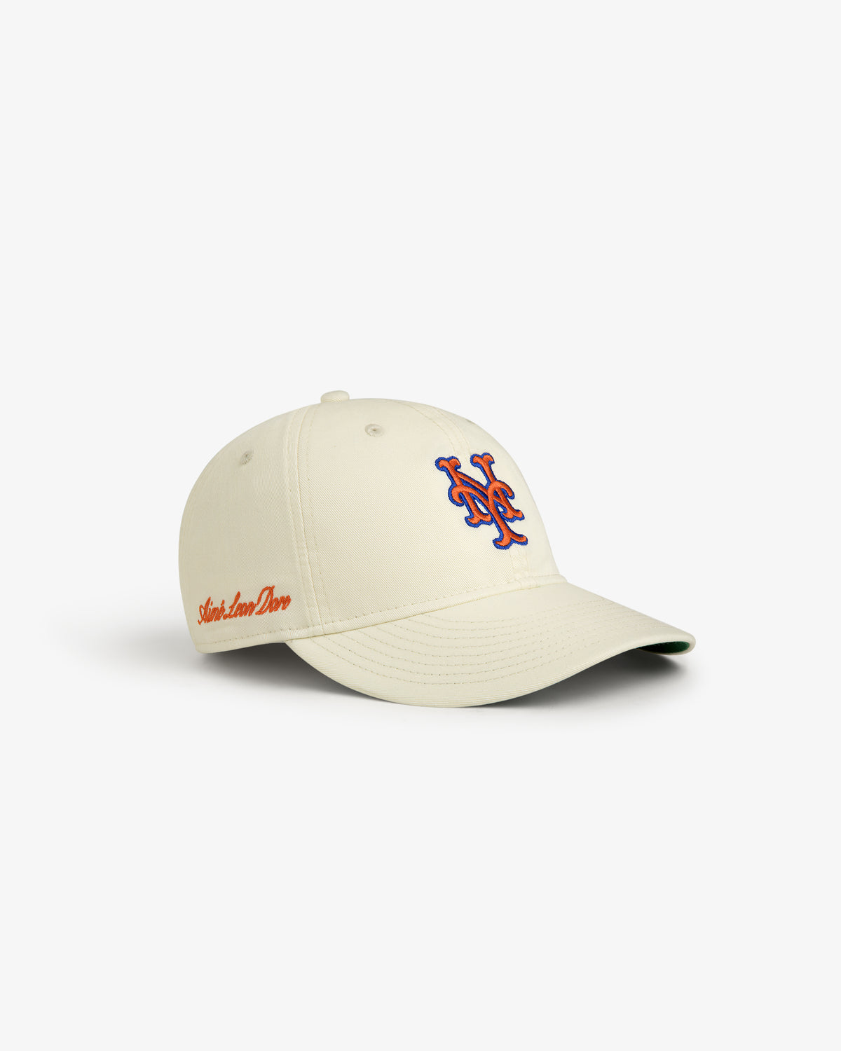 ALD / New Era Mets Retro Fit Hat: beige cap with blue/orange logo and red side script, on a white background.
