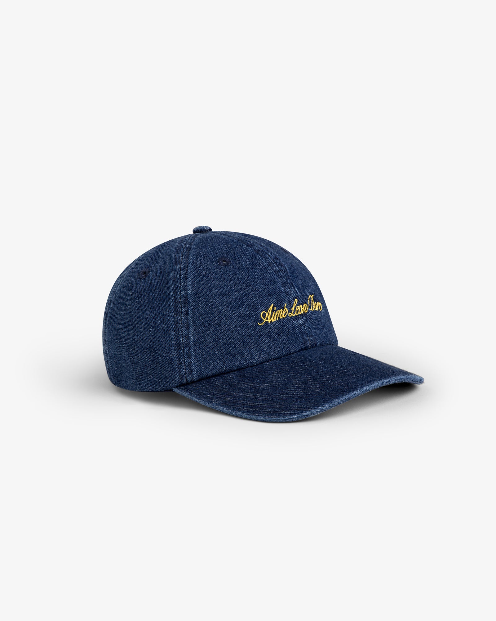 Denim Script Hat: blue denim baseball cap with yellow Aimé Leon Dore embroidery, shown on white background.