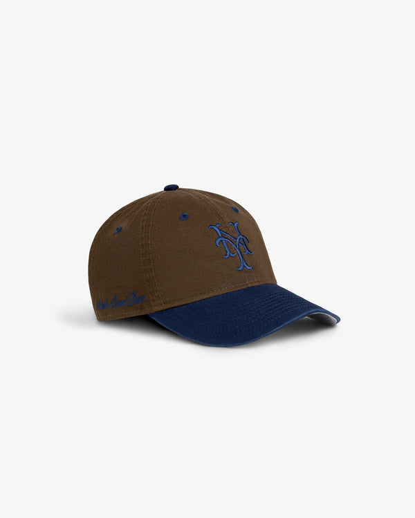 ALD / New York Mets Colorblock Ballpark Hat: brown/navy cap with blue NY logo front, script text left, white background.