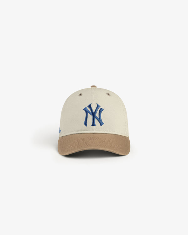 ALD / New York Yankees Colorblock Ballpark Hat features a beige cap, brown brim, and blue NY logo on a white backdrop.