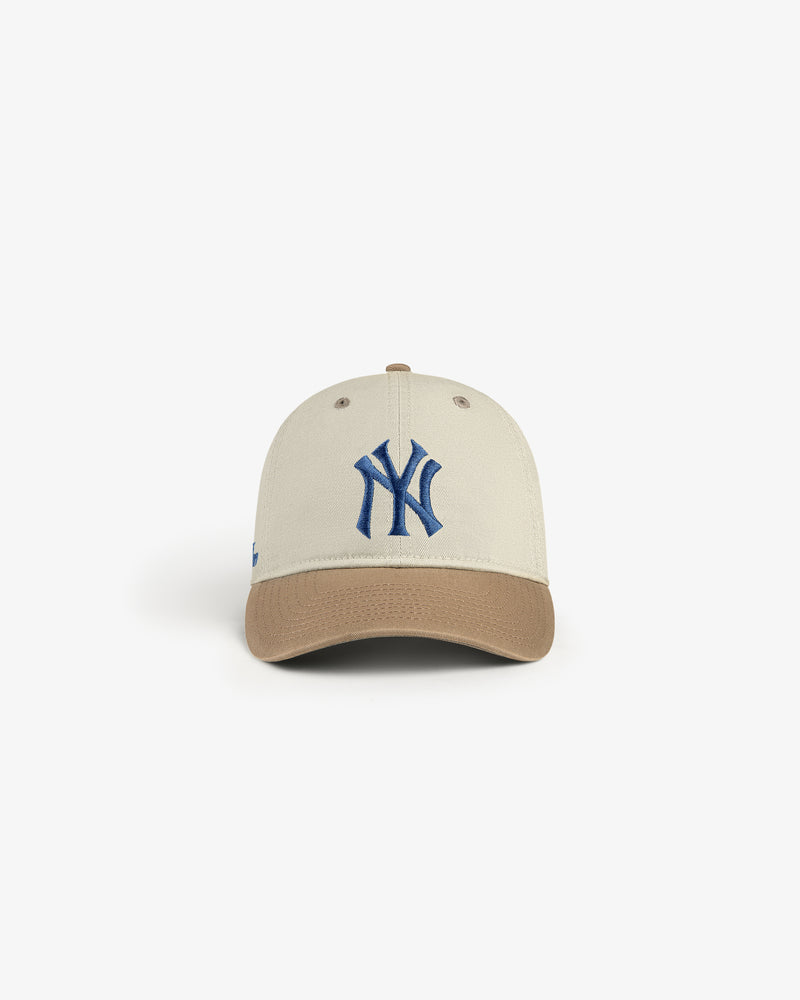 ALD / New York Yankees Colorblock Ballpark Hat features a beige cap, brown brim, and blue NY logo on a white backdrop.