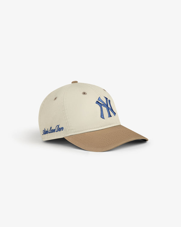 ALD / New York Yankees Colorblock Ballpark Hat in beige and brown with blue NY logo and Aimé Leon Dore side text.