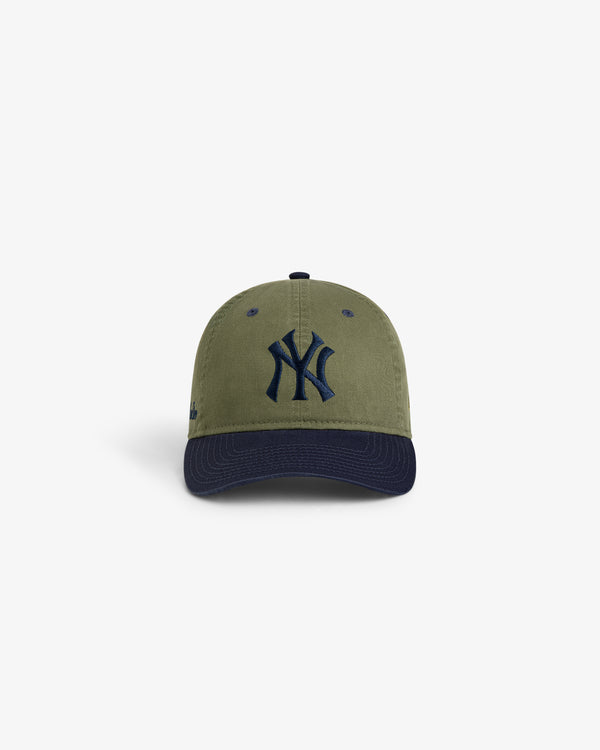 Front view of the ALD / New York Yankees Colorblock Ballpark Hat in olive green with navy "NY" logo and brim.