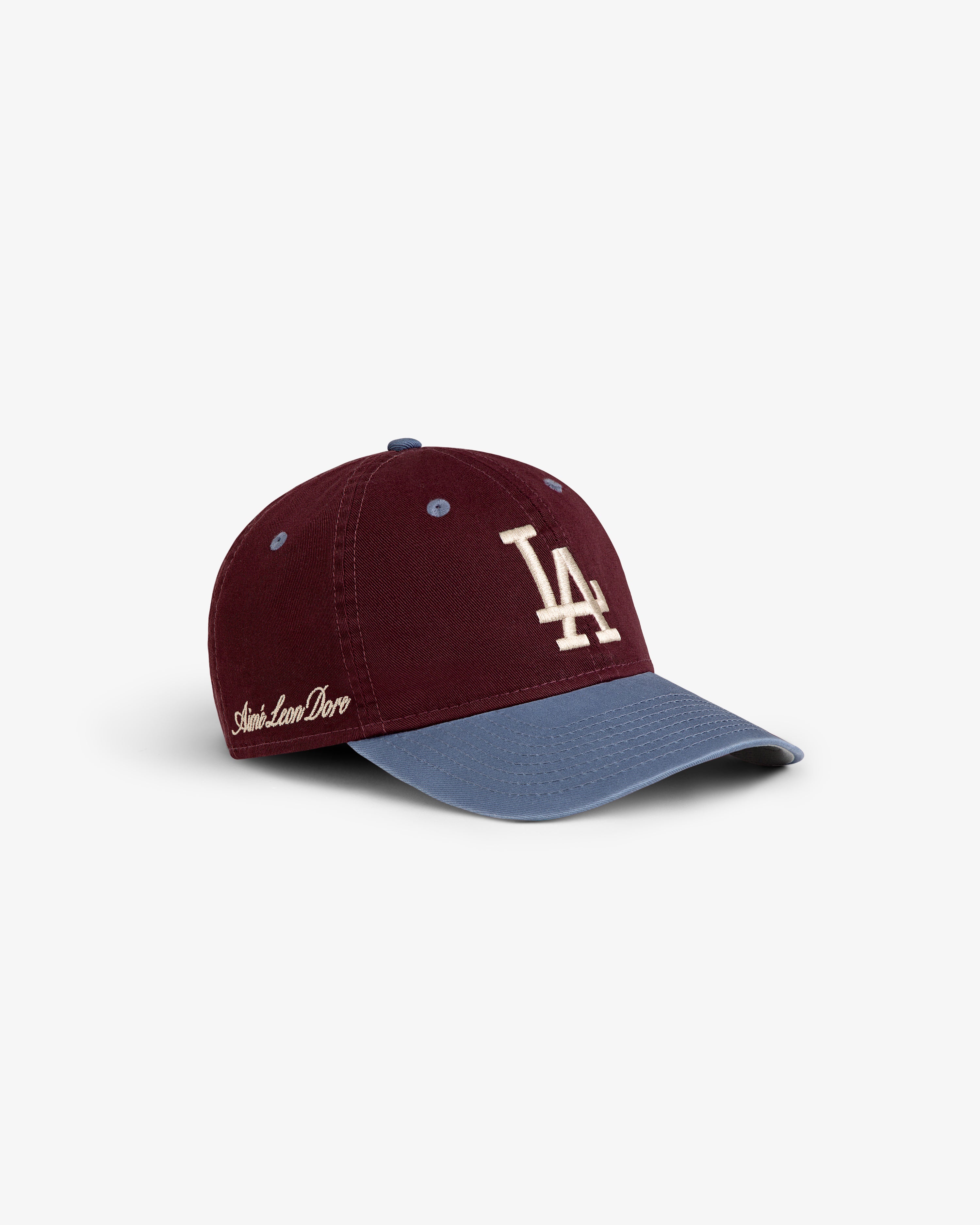 ALD / LA Dodgers Colorblock Ballpark Hat in maroon and blue with white LA logo and Aimé Leon Dore text on the side.