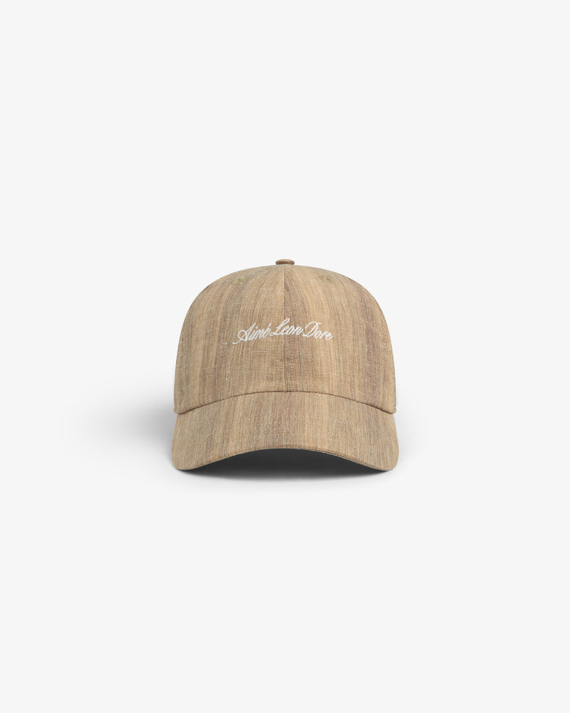 Safari Heritage Hat: light brown textured baseball cap with white embroidered script, shown on a plain white background.