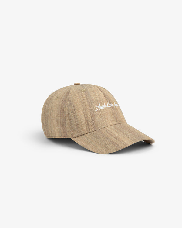Safari Heritage Hat: light brown textured baseball cap with white front embroidery, shown on a plain white background.