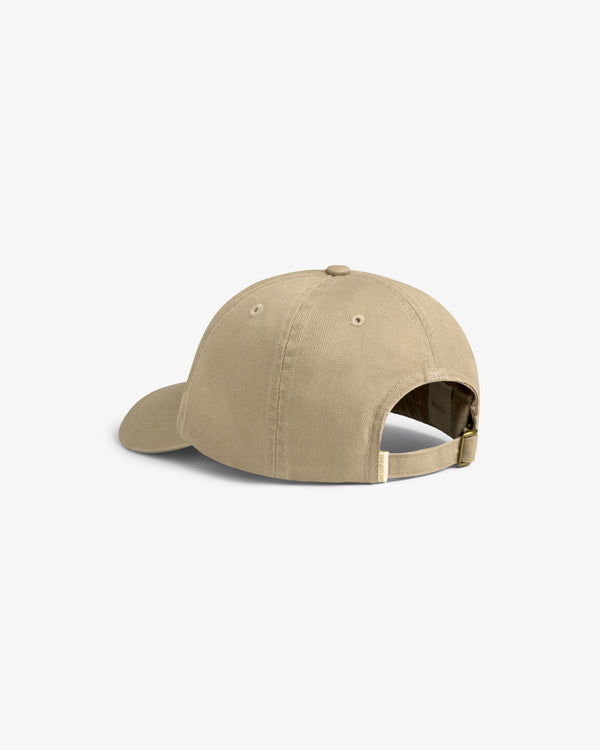 The Cycling Logo Hat is a tan baseball cap with an adjustable strap and metal buckle, shown from the back.