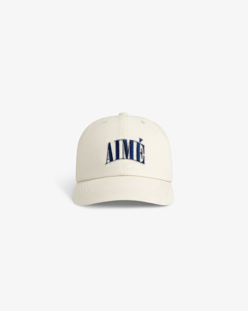 Cream-colored Nylon Crusher Hat with AIMÉ embroidered in bold navy blue on the front, shown on a white background.