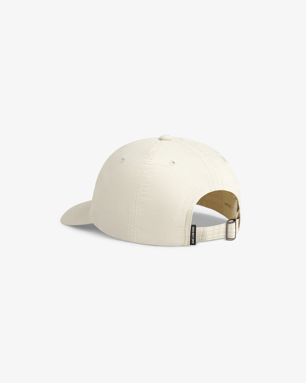 Off-white Nylon Crusher Hat shown from the back with an adjustable strap, metal clasp, and small tag.