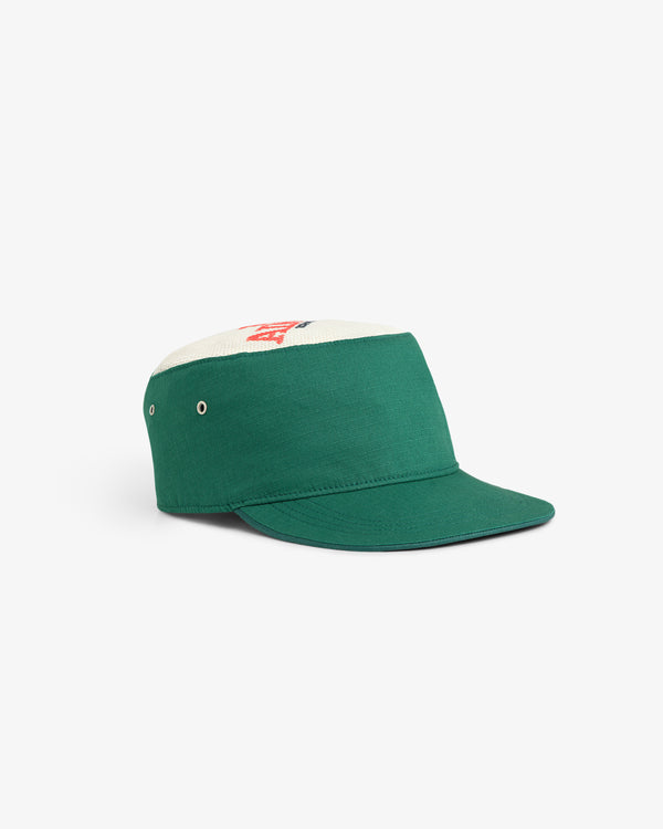 The Aimé Painters Hat is a green and white five-panel cap with a flat brim and side ventilation eyelets.