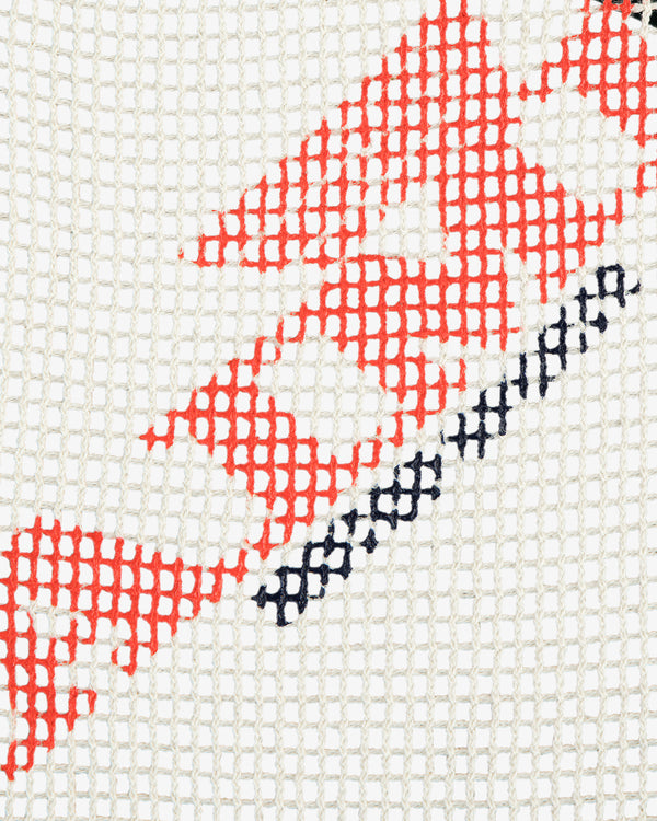 Close-up of the Aimé Painters Hat featuring white mesh and red and black geometric patterns.