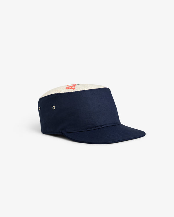 The Aimé Painters Hat, navy blue with a white mesh top and red lettering, shown on a plain white background.