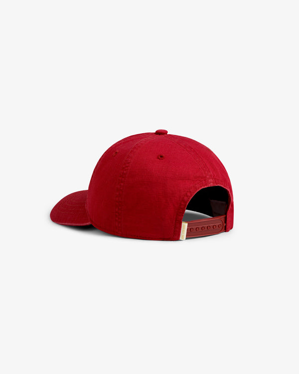 The Sun Faded Unisphere Hat is a red cap with a curved brim and an adjustable strap, shown from the back.
