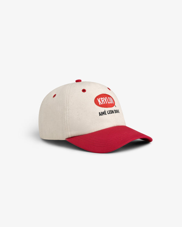 The Krylon Logo Hat is a beige baseball cap with a red brim and red KPHL(C) and AIMÉ LEON DORE text on the front.
