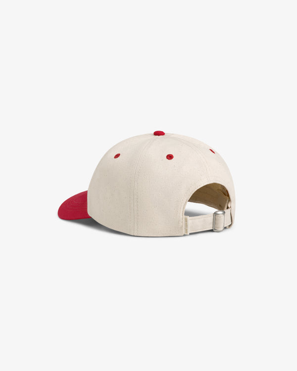 The Krylon Logo Hat is cream with a red brim and adjustable strap, shown from the back on a white background.